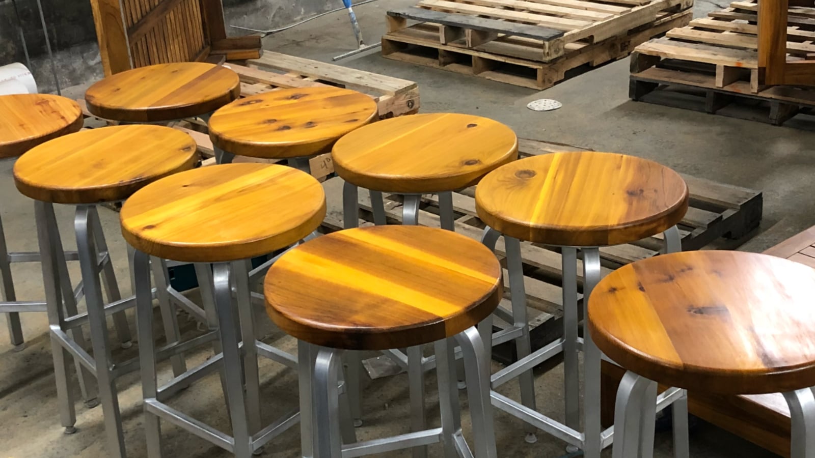 Cedar barstool tops built for three-season use on the rooftop bar