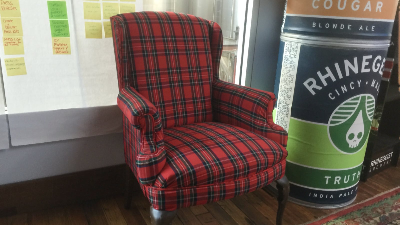 Finished wingback chair in red plaid, the pattern matched across the back, seat, and arms